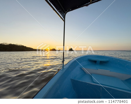 Tour boat on sunset landscape 114778401