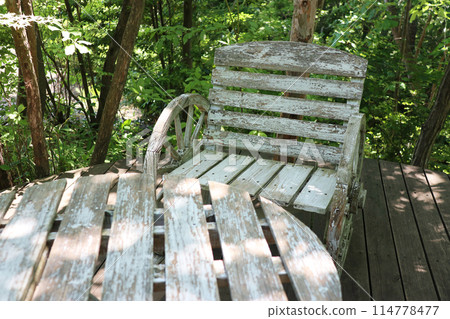 Old wooden table and chairs outdoors 114778477