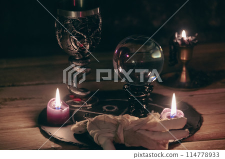 Mysterious Occult Ritual Setup with Crystal Ball and Candles. Mysterious Occult Ritual Setup with Crystal Ball and Candles. 114778933