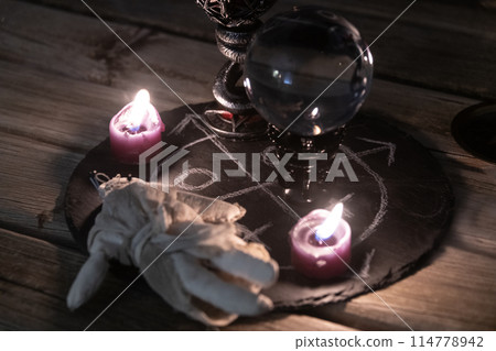 Mysterious Occult Ritual Setup with Crystal Ball and Candles. Mysterious Occult Ritual Setup with Crystal Ball and Candles. 114778942