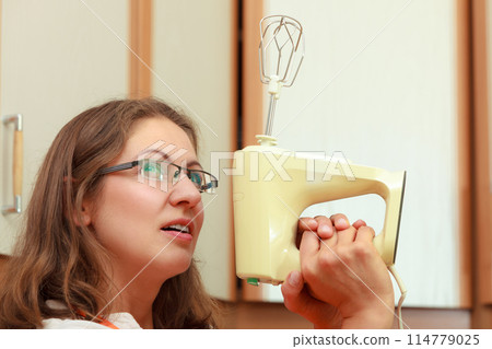 Funny housewife with mixer 114779025