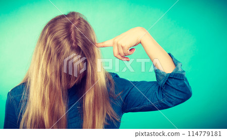 Depressed blonde woman covering face. Depressed blonde woman covering face. 114779181