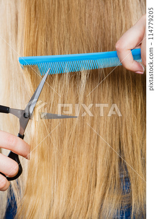 Woman cutting down smoothy hair. 114779205