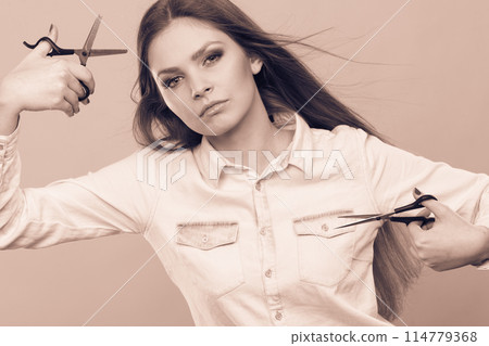 Passionate female hairdresser. 114779368