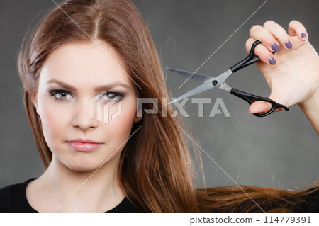 Professional elegant female barber with scissors. Professional elegant female barber with scissors. 114779391
