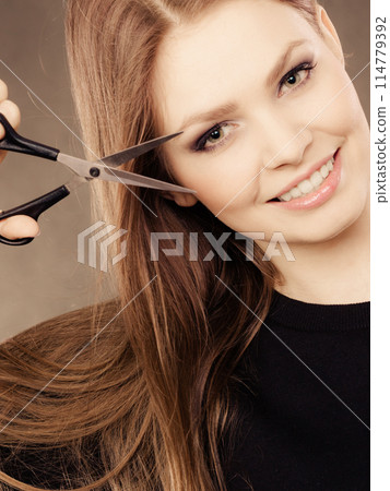 Professional hairdresser with scissors ready to cut. Professional hairdresser with scissors ready to cut. 114779392