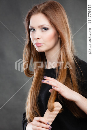 Long haired girl combing her beauty hair. Long haired girl combing her beauty hair. 114779415