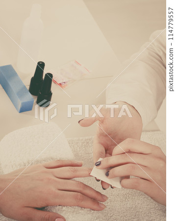 Woman making manicure using nail polish remover Woman making manicure using nail polish remover 114779557