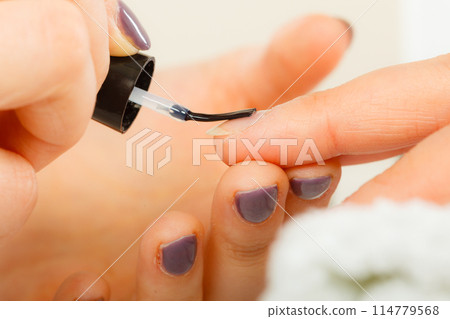 Woman in beauty salon getting manicure done. 114779568