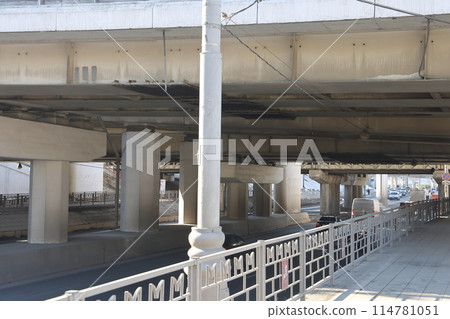 Overpasses on the background of skyscrapers. Blue sky and bright sun. Overpasses on the background of skyscrapers. Blue sky and bright sun. 114781051