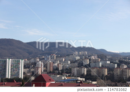 Beautiful view of residential buildings of a green resort at sunset high in the mountains in Sochi Beautiful view of residential buildings of a green resort at sunset high in the mountains in Sochi 114781082