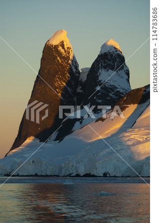 Lemaire strait coastal landscape, mountains and icebergs, Antarctic Peninsula, Antartica. 114783686