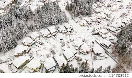 Snow Covered Homes in Suburban neighborhood. 114783912