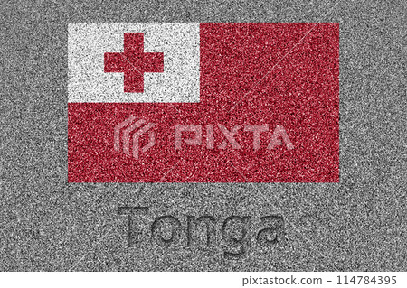 The Tongan flag painted on a stone slab and the word "Tonga" carved into it 114784395