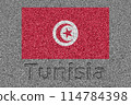 The Tunisian flag painted on a stone slab with the word "Tunisia" carved into it 114784398