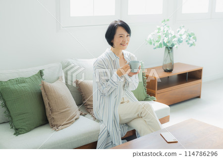 Middle-aged woman relaxing at home 114786296