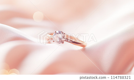 Jewellery, proposal and holiday gift, diamond engagement ring on pink silk fabric, symbol of love, romance and commitment inspiration 114788321