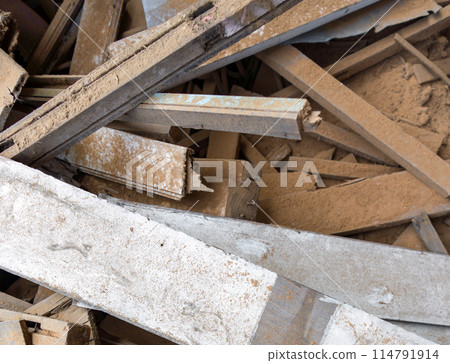 White wooden board lay on the leftover wooden pieces. Stacked together in a pile. Top view 114791914