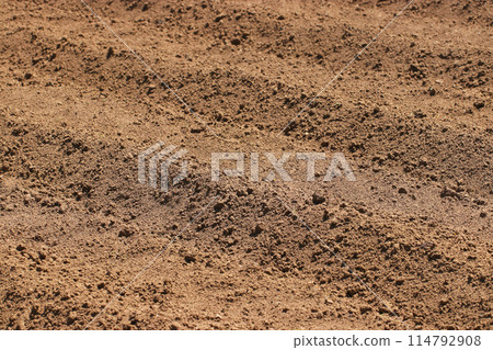 Texture of fertile farmland that has been neatly plowed and ridged Texture of fertile farmland that has been neatly plowed and ridged 114792908