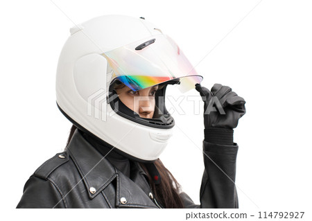 A girl on a motorcycle opens the shield of her full-face helmet 114792927
