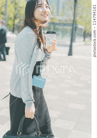 A working woman taking out hot coffee A working woman taking out hot coffee 114794181