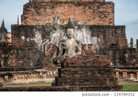 Beautiful Buddha statue in Wat Mahathat temple the most important and impressive temple compound in Sukhothai Historical Park. Beautiful Buddha statue in Wat Mahathat temple the most important and impressive temple compound in Sukhothai Historical Park. 114794352