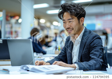 AI-generated image: A young businessman working on a computer 114794395