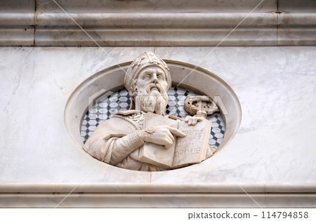 Saint, relief on the facade of Basilica of Santa Croce (Basilica of the Holy Cross) - famous Franciscan church in Florence, Italy 114794858