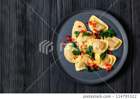 italian pasta mezzelune on a plate, top view italian pasta mezzelune on a plate, top view 114795322