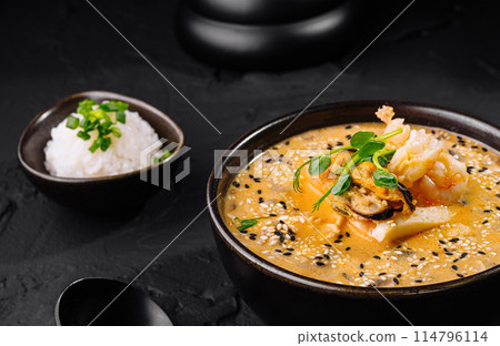 Spicy kimchi stew in black bowl Spicy kimchi stew in black bowl 114796114