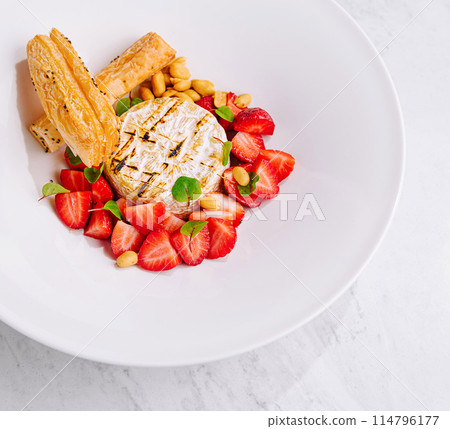 Top-view of a beautifully plated bbq cheese with strawberries and puff pastry 114796177