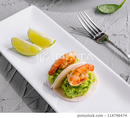 shrimp appetizer with slice of lime on elegant plate 114796474
