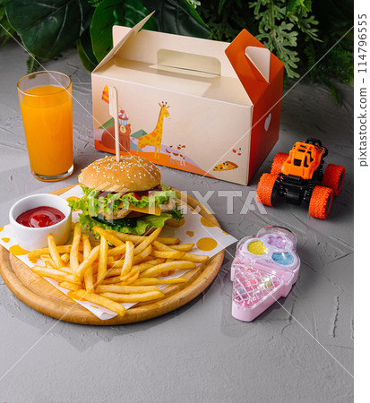 Kid's meal with toy and juice on table Kid's meal with toy and juice on table 114796555