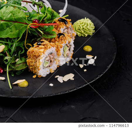Gourmet sushi roll on elegant black plate Gourmet sushi roll on elegant black plate 114796613
