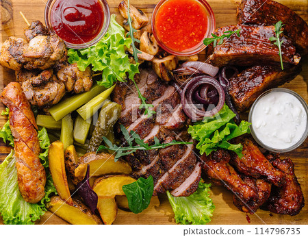 Assorted grilled meat and vegetable platter with sauces Assorted grilled meat and vegetable platter with sauces 114796735