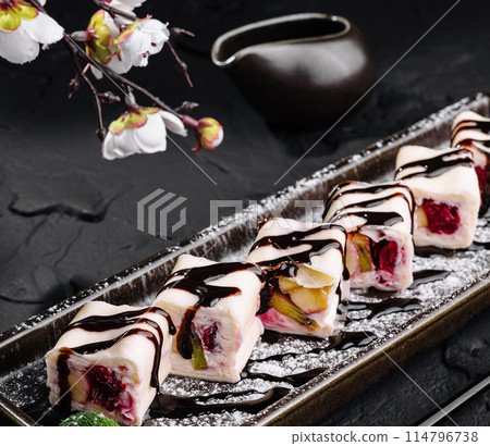 Gourmet fruit sushi rolls on elegant slate plate 114796738