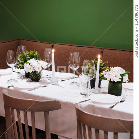 Elegant dining table setting with candlelight 114796772