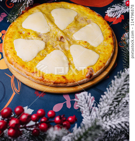 Festive cheese pizza under christmas tree Festive cheese pizza under christmas tree 114796878