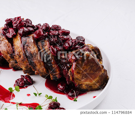 Roasted pork tenderloin with cherry sauce Roasted pork tenderloin with cherry sauce 114796884