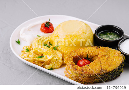 Traditional romanian mamaliga with grilled cheese and sides Traditional romanian mamaliga with grilled cheese and sides 114796919