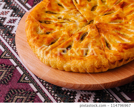 Traditional georgian khachapuri bread on ethnic tablecloth Traditional georgian khachapuri bread on ethnic tablecloth 114796967