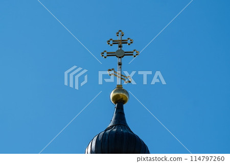 Ornate Church Cross Against Clear Blue Sky Ornate Church Cross Against Clear Blue Sky 114797260