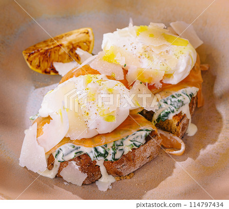 Gourmet poached eggs on toast with herbs 114797434