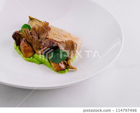 Gourmet seared fish fillet on pea puree Gourmet seared fish fillet on pea puree 114797498