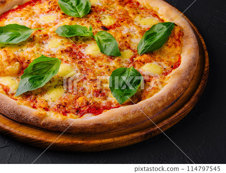 Margherita pizza on black surface 114797545