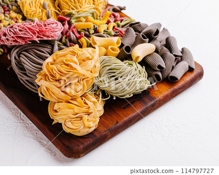 Colorful pasta assortment on wooden board 114797727