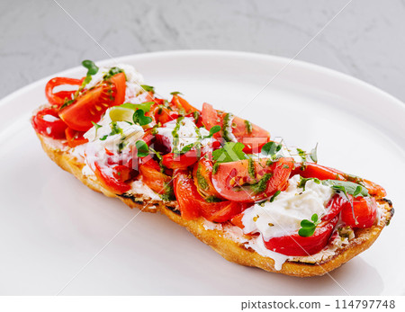 Fresh tomato and cheese bruschetta on plate Fresh tomato and cheese bruschetta on plate 114797748