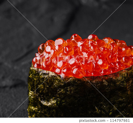 Exquisite salmon roe sushi on dark slate Exquisite salmon roe sushi on dark slate 114797981