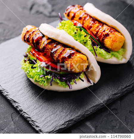 Gourmet grilled chicken bao buns on slate 114798060