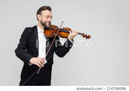 Elegant man violinist on stage performing concert 114798086